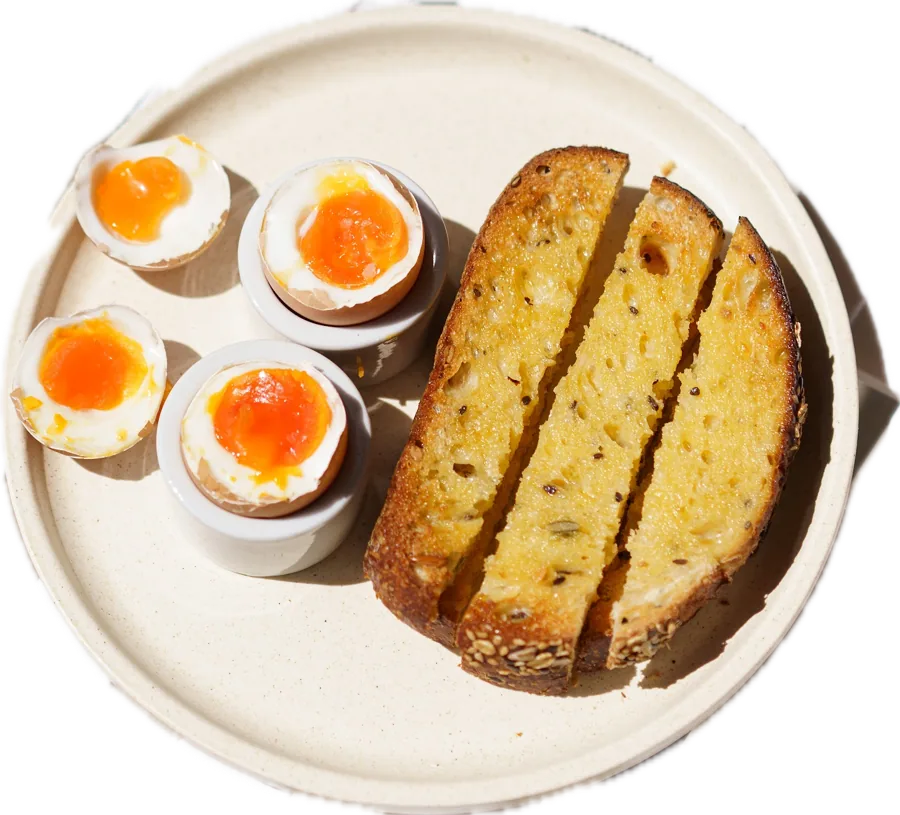 Soft boiled eggs in cups with sourdough soldiers