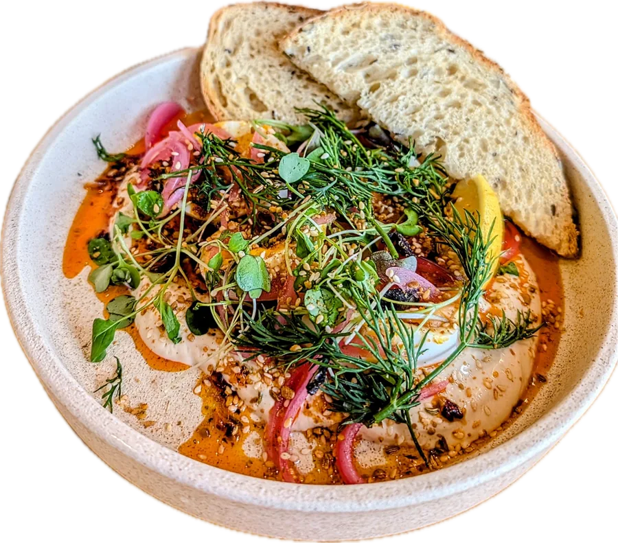 Turkish eggs with chilli butter, herbs and pickled onion, with toasted sourdough